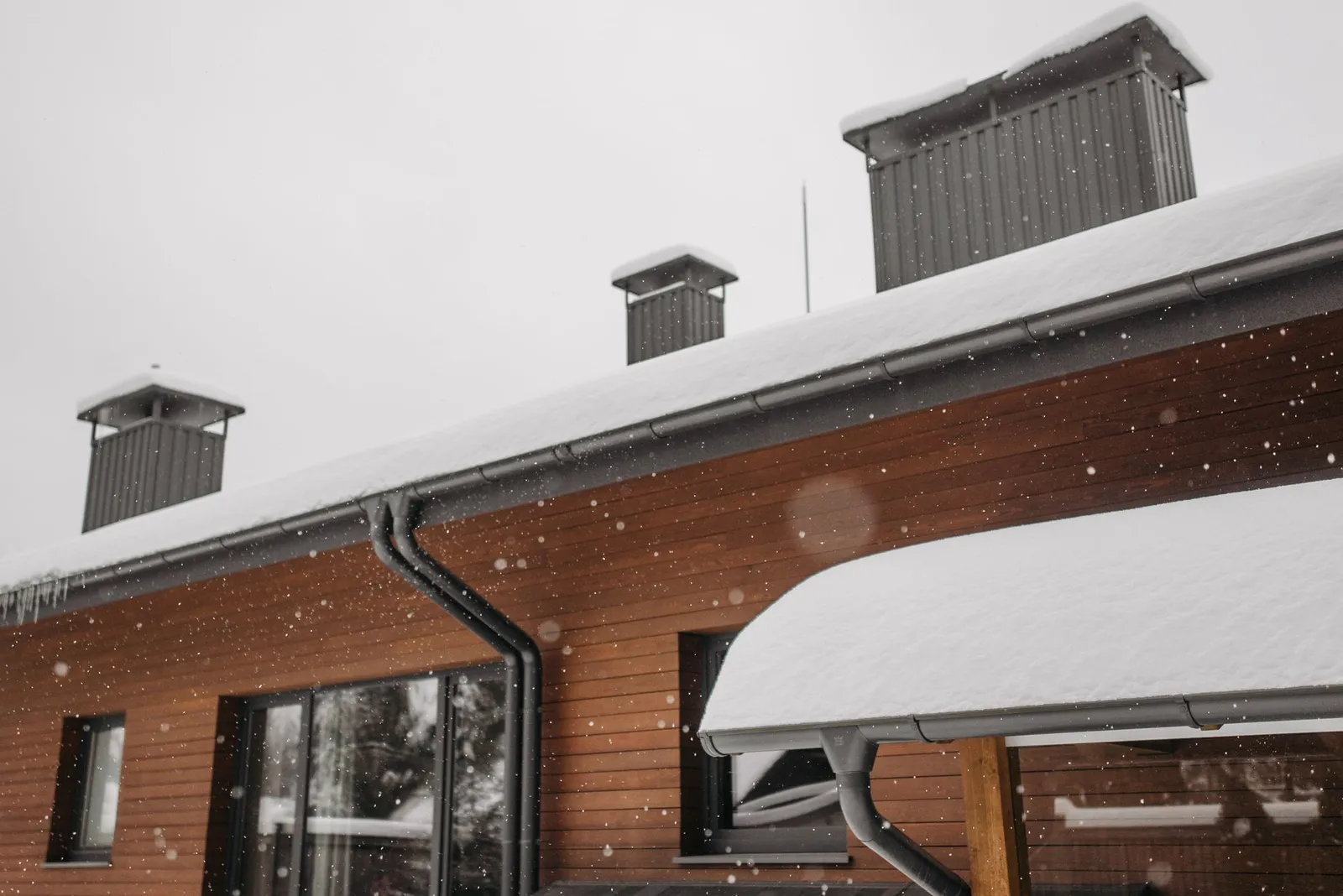 Seamless gutters and downspouts on a modern home by ORC in Eastern Iowa