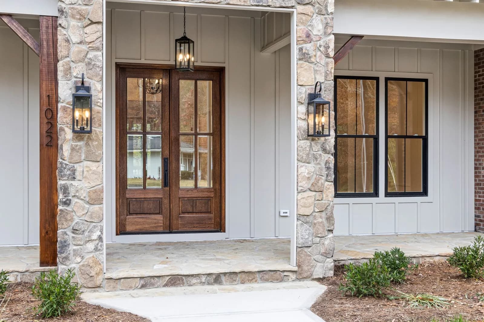 Stone-and-trim entry with new doors and windows by ORC in Iowa City